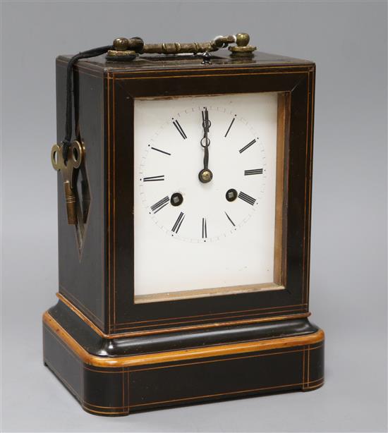 A line-inlaid boxwood and ebonised carriage clock, striking on bell, with white enamelled Roman dial